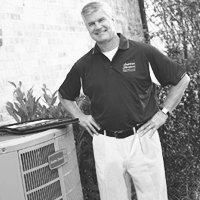American Standard dealer standing outdoors next to American Standard Air Conditioner